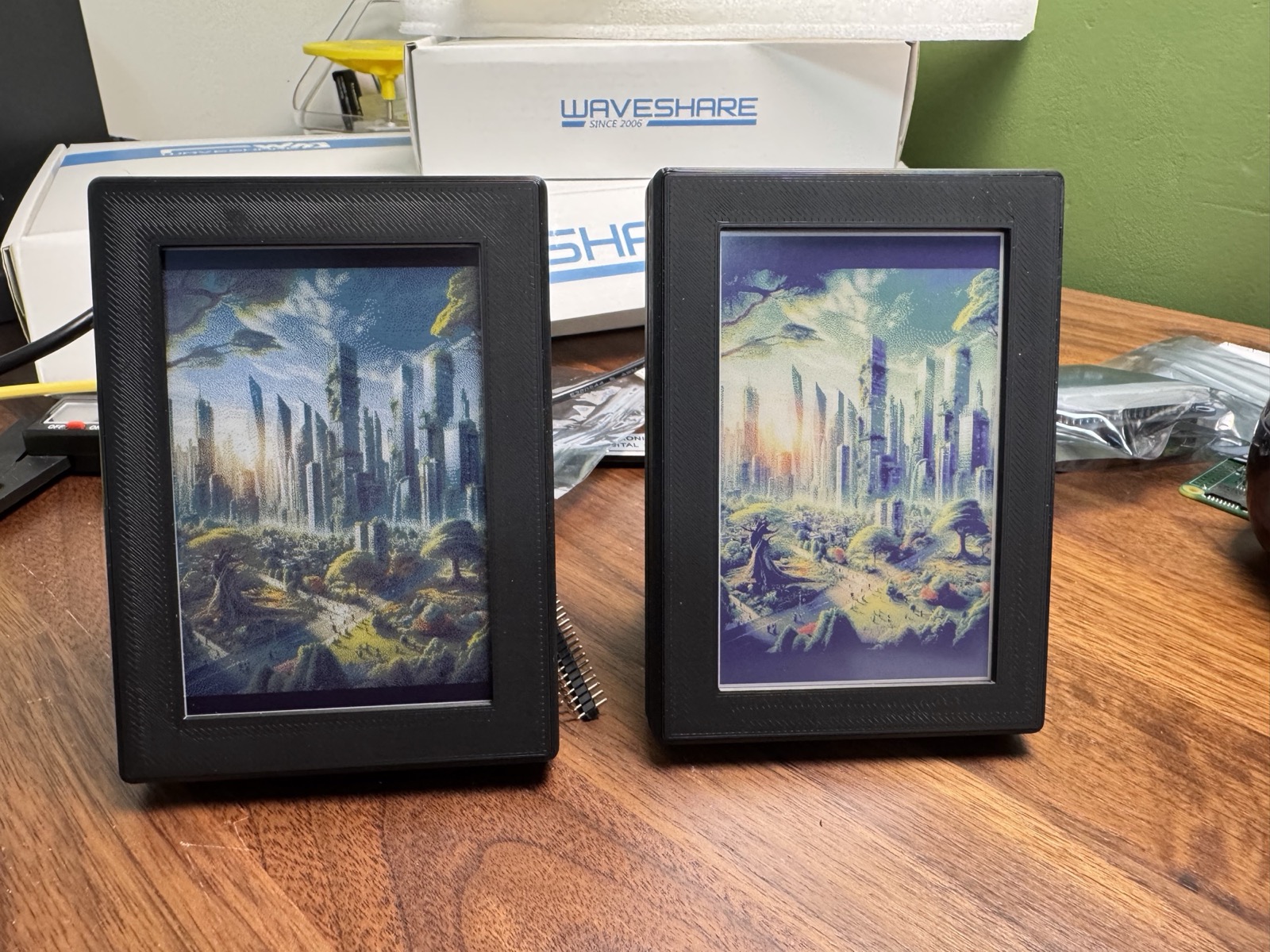 Two 4 inch frames side by side, one with a Spectra 6 panel and one with an ACeP panel